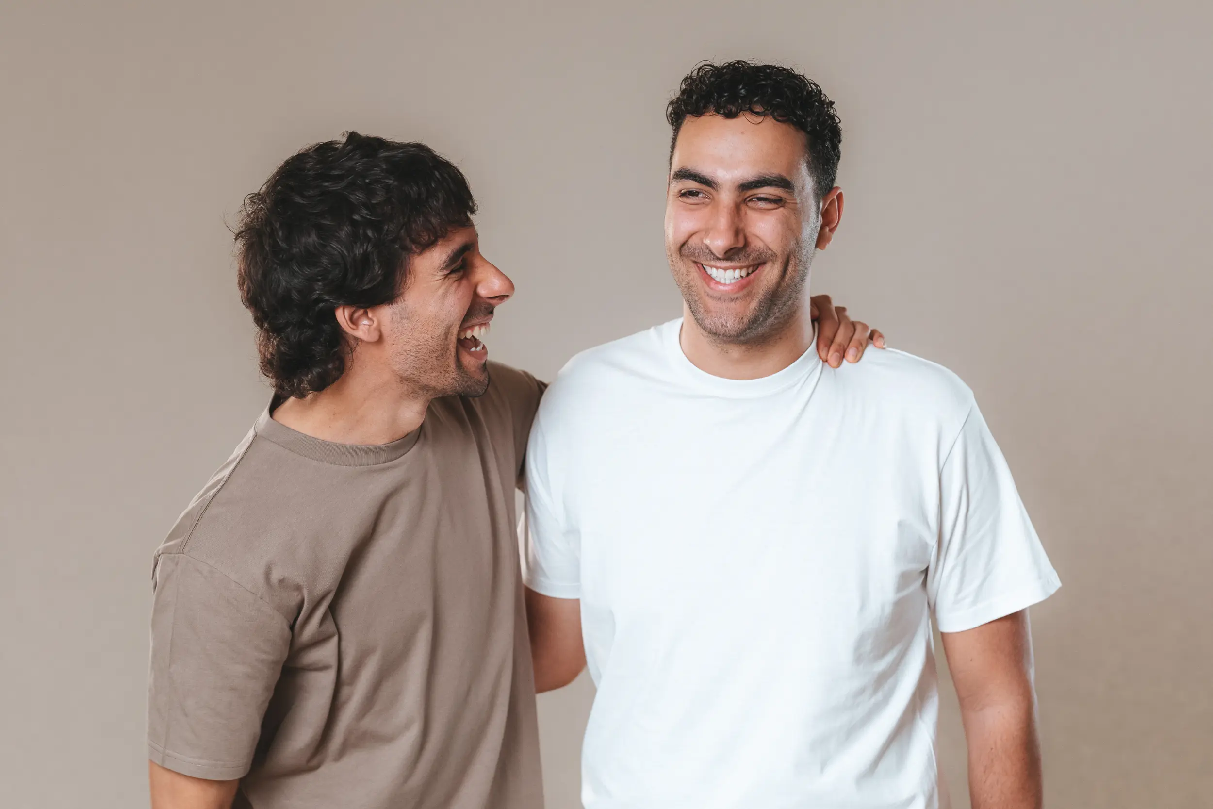 Sav and Dom Tripodi laughing at a photoshoot back in 2023